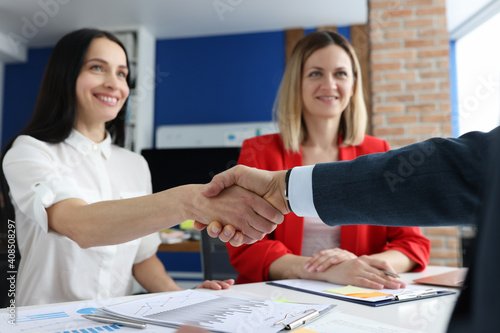 Foto Closeup of successful business people handshake in office