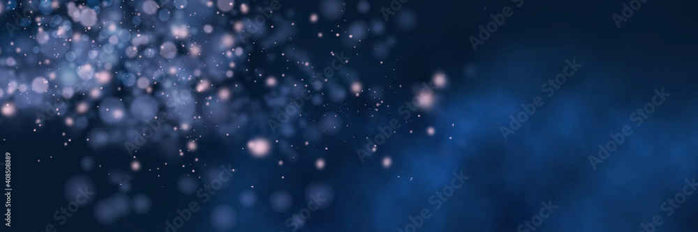 Blurred bokeh light on dark blue background. Christmas and New Year holidays template. Abstract panoramic background.