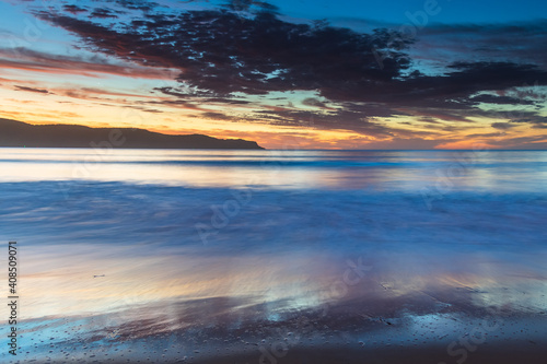 Pretty blue summer sunrise seascape with high cloud