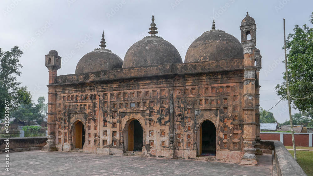 View of old Nayabad countryside mosque with terracotta facade in Dinajpur district, Bangladesh