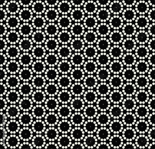 A pattern with white circles and small stars on a dark, dark background