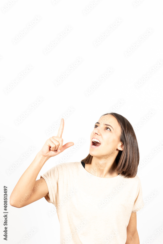 A latin woman having an idea. Pointing up to copy space. A latin woman having an idea. Pointing up to copy space.