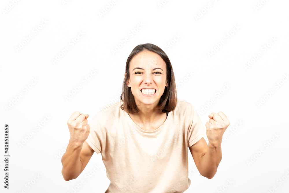 A happy latin woman celebrating a victory with anger. A happy latin woman celebrating a victory with anger.