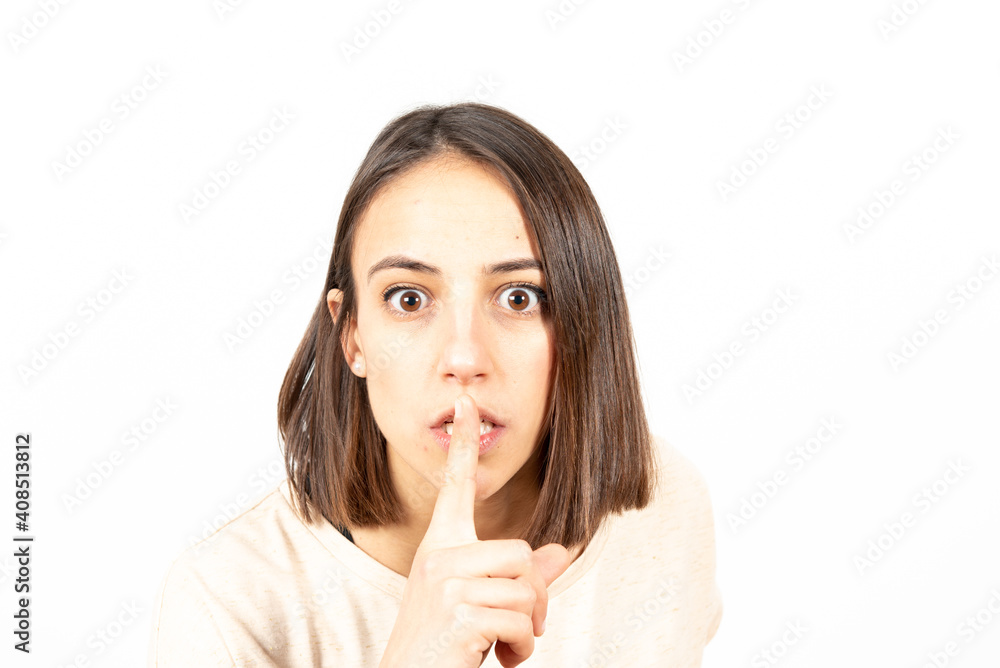 Closeup portrait of a latin woman asking for silence with the finger on her mouth. Closeup portrait of a latin woman asking for silence with the finger on her mouth.