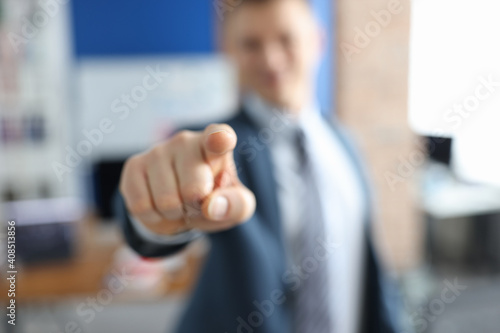 Man in business suit pointing his finger in front of him closeup
