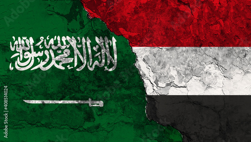 Concept of a Conflict between Saudi Arabia and Yemen with painted flags on a wall with a crack