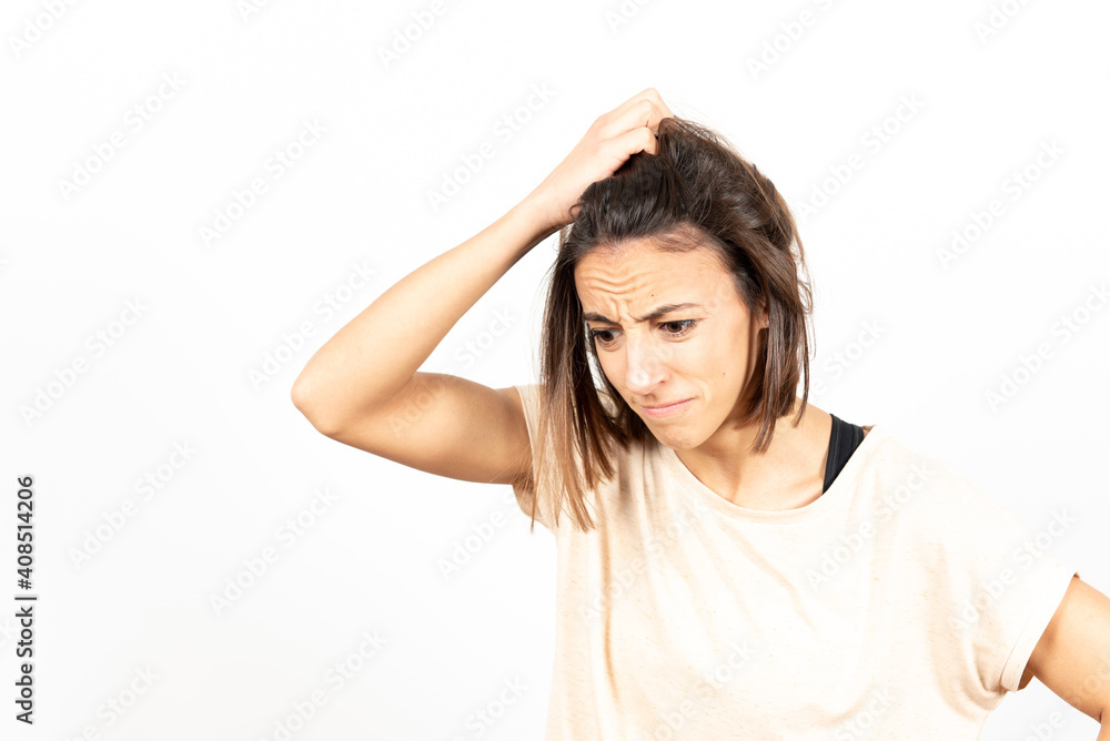 A despaired and worried brunette young woman. Mental health and psychology concept. A despaired and worried brunette young woman. Mental health and psychology concept.