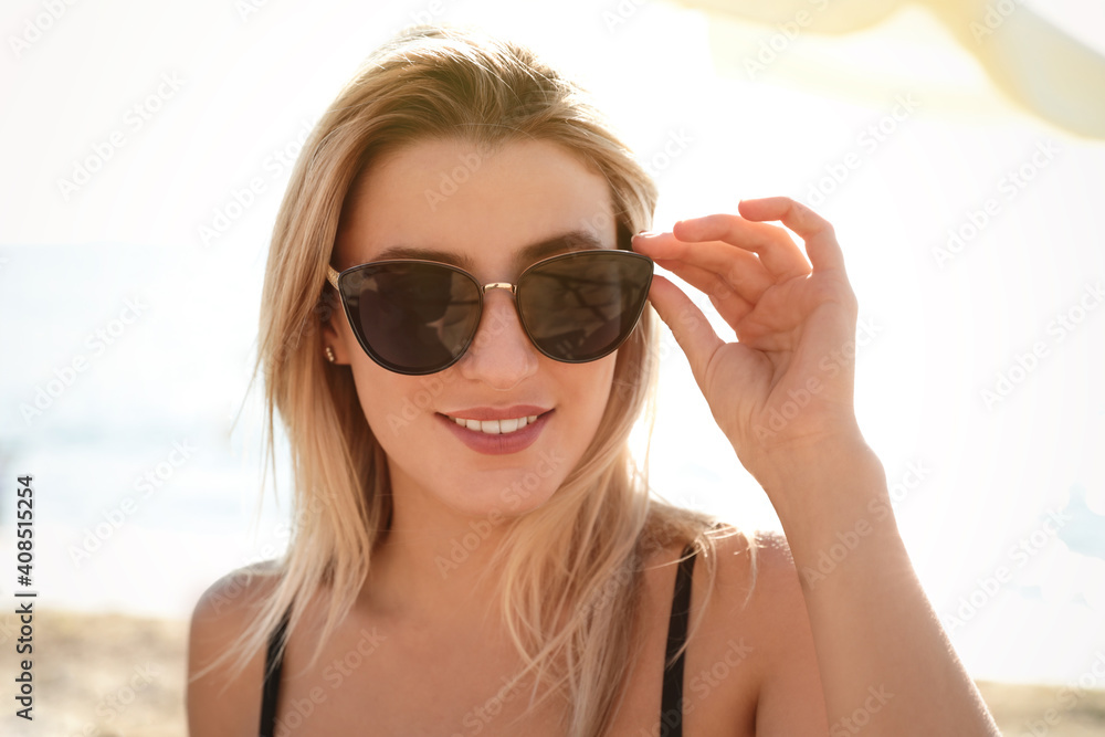 Beautiful woman wearing sunglasses outdoors on sunny day Beautiful woman wearing sunglasses outdoors on sunny day