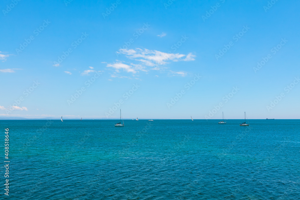 Blue ocean with yachts .  Sailing ships at opened sea
