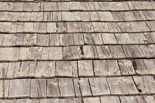 Natural pine wood panels from a wooden roof of a mountain stable