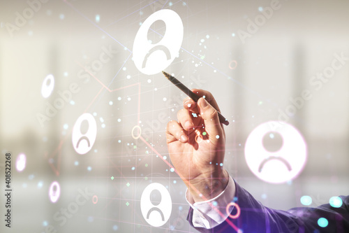 Wallpaper Mural Double exposure of businessman hand with pen working with social network icons on blurred office background. Networking concept Torontodigital.ca