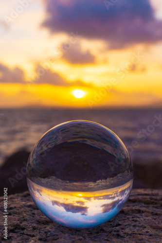 glass ball on the beach at sunset © Francesca