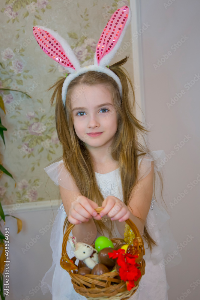 A girl dressed as an Easter bunny with a basket of chocolate eggs A girl dressed as an Easter bunny with a basket of chocolate eggs