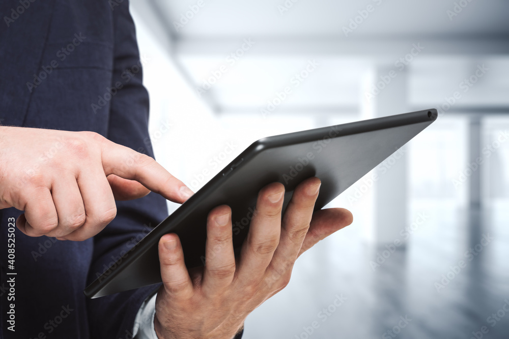 Businessman holds digital tablet and clicks on screen in modern office, close up. Search concept Businessman holds digital tablet and clicks on screen in modern office, close up. Search concept