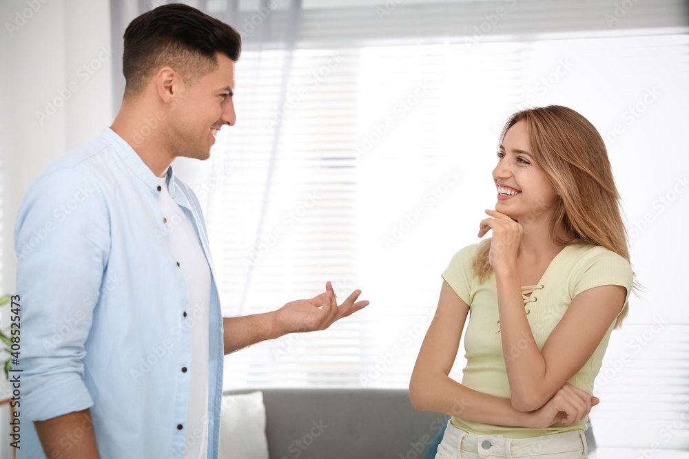 Man and woman talking in living room Man and woman talking in living room