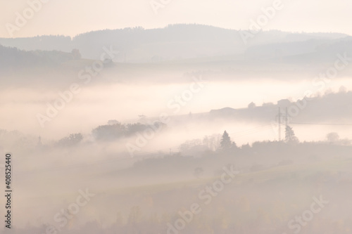 Landscape with hills in soft light and fog