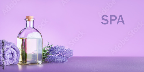 Spa banner witn natural essence  towel and lavender flowers.