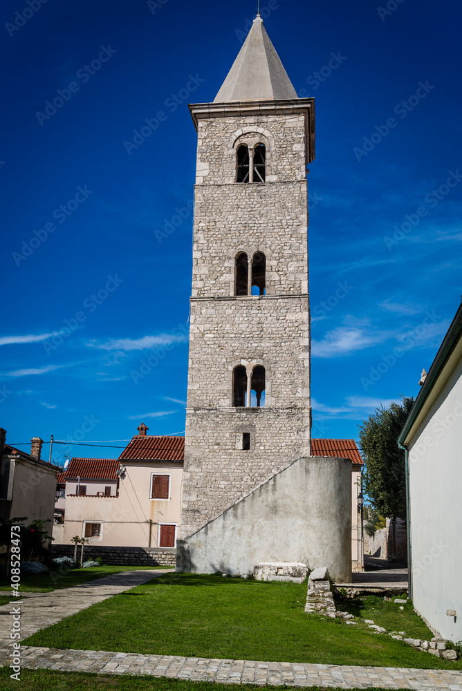 Fototapeta premium Bell tower of the Church of St Anselm from 12th century, Nin, a historic town in the Zadar County, Dalmatia, Croatia