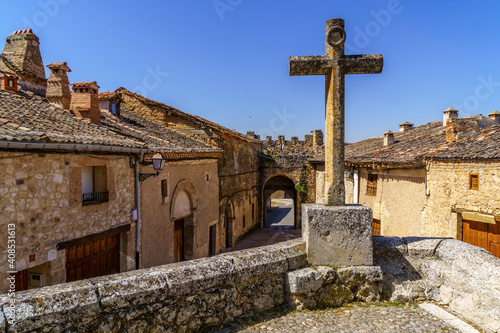 Medieval village with stone houses, cobblestone streets, old doors and windows, arches and walls. Maderuelo Segovia Spain. 