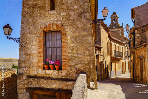 Medieval village with stone houses, cobblestone streets, old doors and windows, arches and walls. Maderuelo Segovia Spain.
 photo