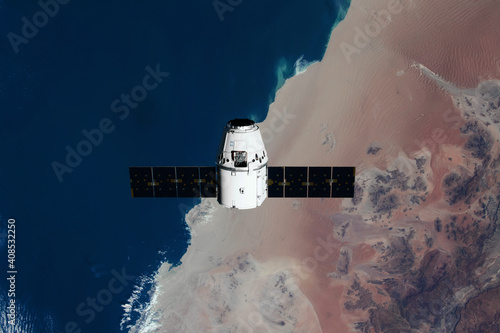 The SpaceX Dragon resupply ship is pictured approaching the International Space Station. Elements of this image furnished by NASA photo