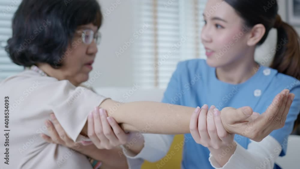 Young senior asia citizen female with scrubs nurse physiotherapy worker at home in rehabilitation therapy service for aging parents. Massage for older care, ache pain joints exercise in old people. Young senior asia citizen female with scrubs nurse physiotherapy worker at home in rehabilitation therapy service for aging parents. Massage for older care, ache pain joints exercise in old people.