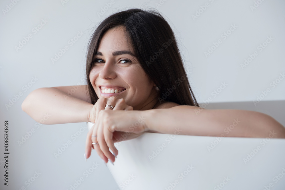Brunette caucasian adult woman lay in bath relaxing. Sensual sexy portrait at home Brunette caucasian adult woman lay in bath relaxing. Sensual sexy portrait at home