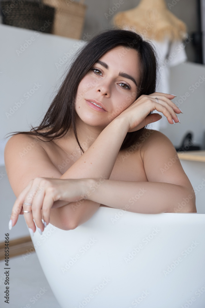 Obraz premium Brunette caucasian adult woman lay in bath relaxing. Sensual sexy portrait at home