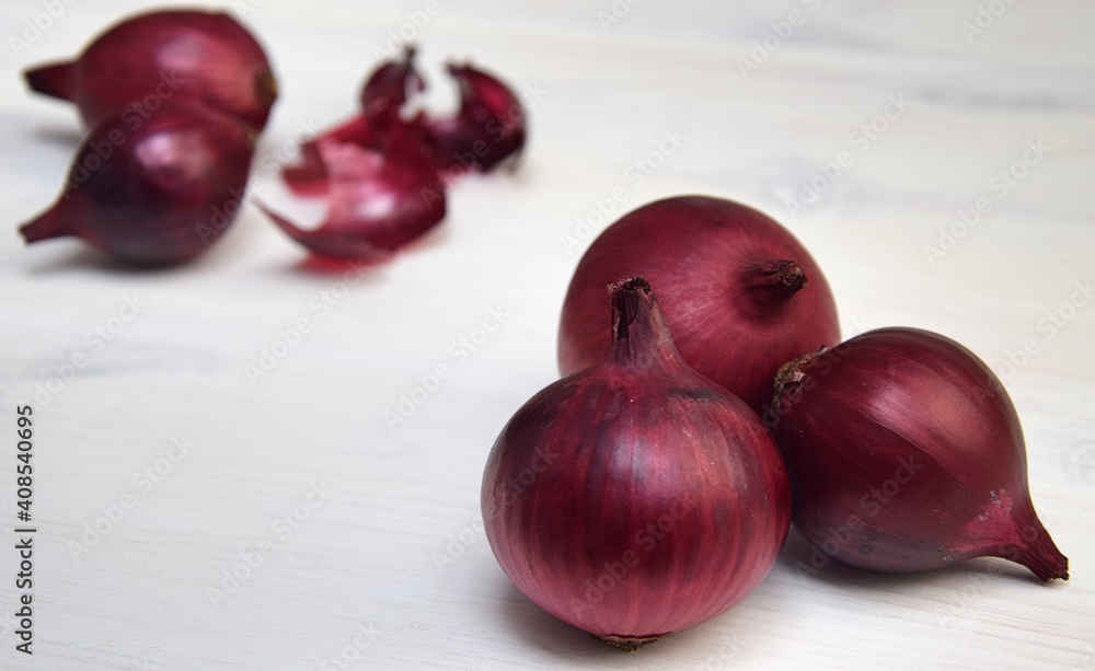 Red onions on white wooden background Red onions on white wooden background
