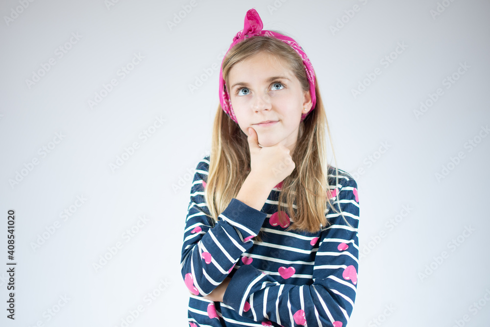 Little girl thinking and looking up, confused about an idea. Little girl thinking and looking up, confused about an idea.
