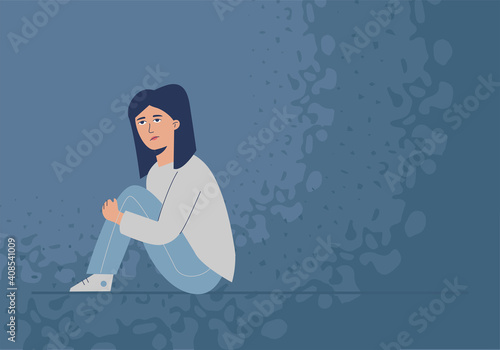 A suppressed, sad girl sits on the floor. The problem of adolescent depression.
