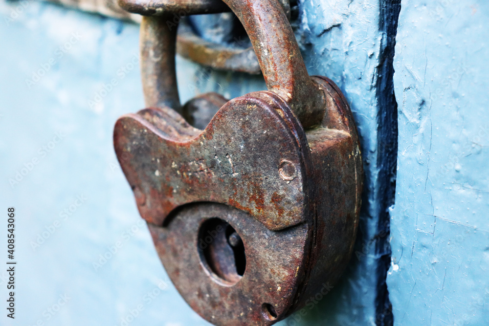 old rusty padlock on blue wooden door old rusty padlock on blue wooden door