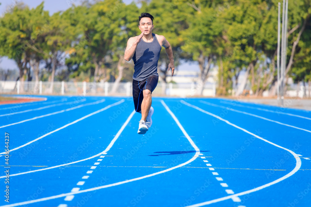 young asian man athlete running and training  on the  track