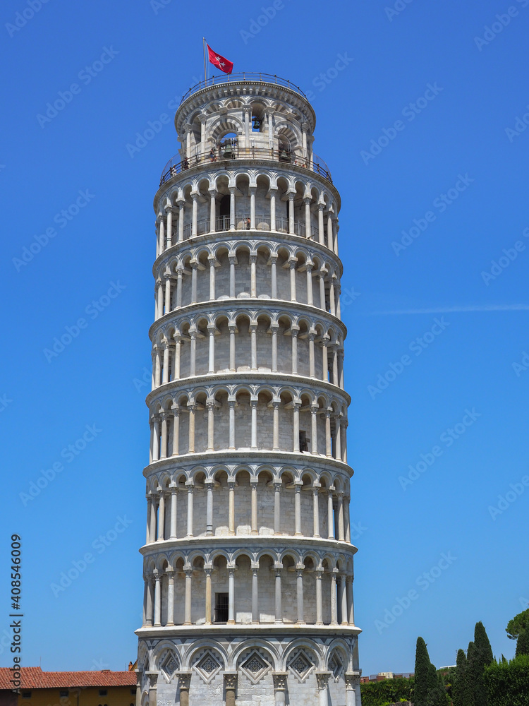 Beautiful and unique, famous and iconic Leaning Tower or Torre pendente di Pisa  is the campanile in Piazza dei Miracoli, Tuscany region, central Italy. Morning with cloudy blue sky in the background.