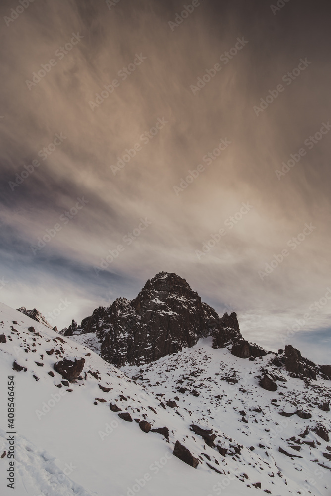 Winter landscape, mountains peaks covered by snow and rocks