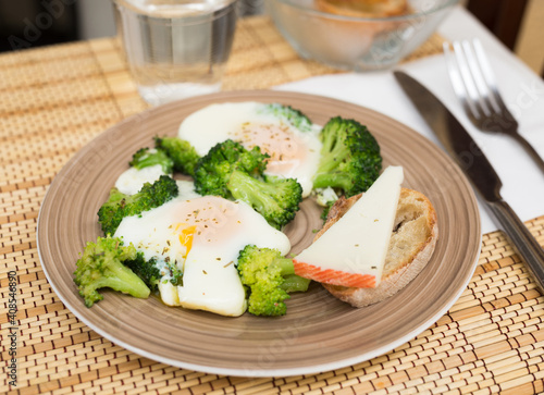 breakfast of crumpled eggs with broccoli