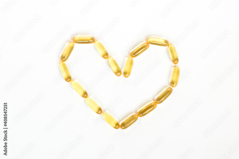 Heart shape made of cod oil capsules. Valentines day and healthy heart concept Heart shape made of cod oil capsules. Valentines day and healthy heart concept