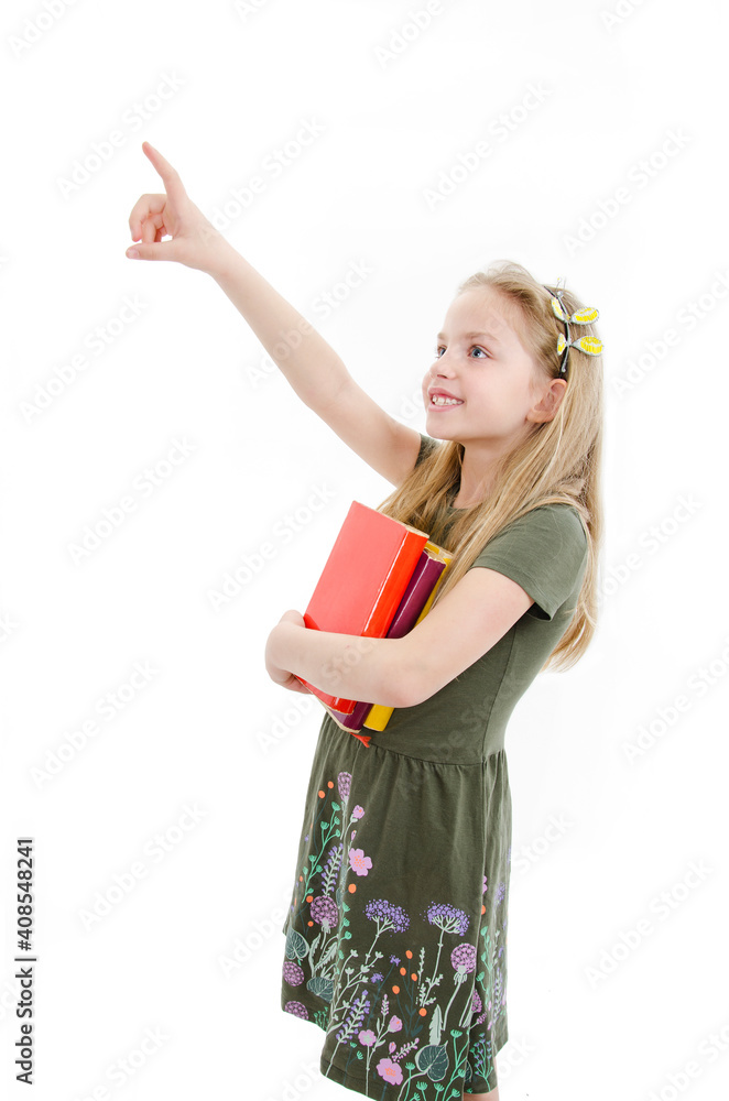 Portrait of beautiful young girl holding books and pointing up. Isolated on white background Portrait of beautiful young girl holding books and pointing up. Isolated on white background