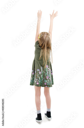 Back view of little girl trying to catch something, isolated on white background