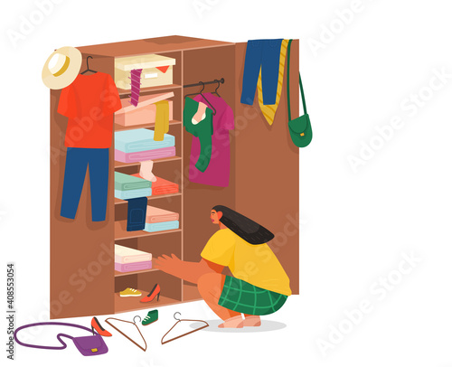 Girl squatting rummages in wooden cabinet. Clothes on hangers in the cupboard. Choose or fold clothes. Mess things. Women s fashion accessories.Wooden furniture with hanger and boxes with clothing