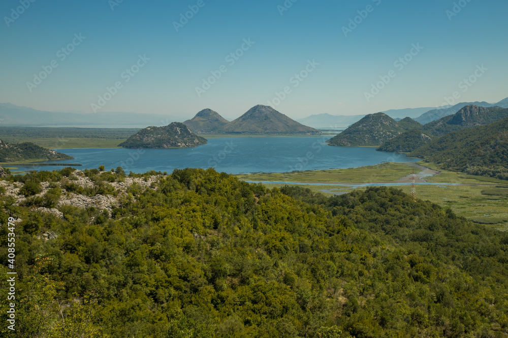 Panoramic view at the Montenegrin part of Skadar lake with highway around. Crnojevica river landscape. Beautiful nature of Montenegro national parks.
