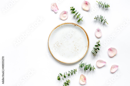 breakfast plate with petals and eucalyptus on white background top view mockup