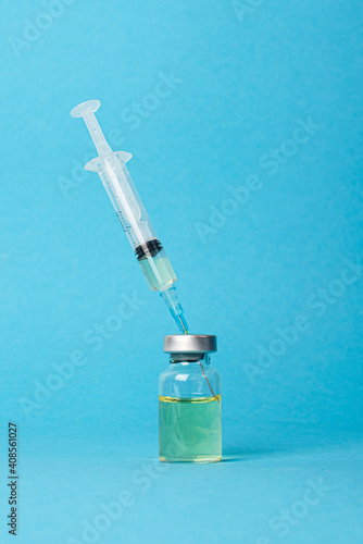 Vaccine and syringe injection on blue background . Preventive,immunization and treatment from corona virus infection. Medicine infectious concept. Copy space