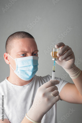Concept fight against virus covid-19 corona virus, doctor or nurse or scientist in laboratory holding a syringe with liquid vaccines. 