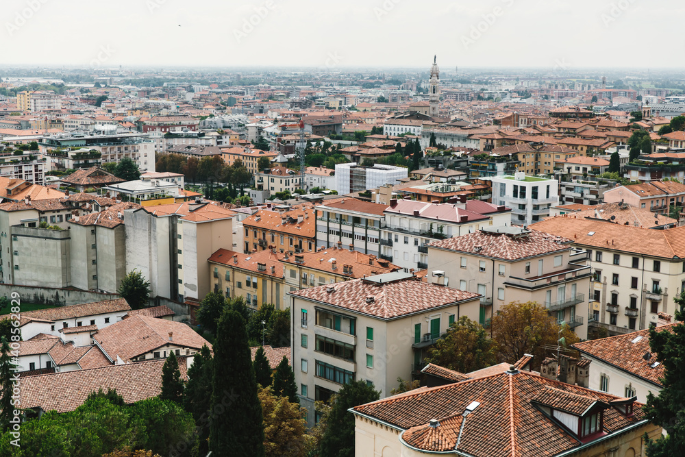 Top view of houses, roofs and streets of old Italian city. City panorama, tourism.
