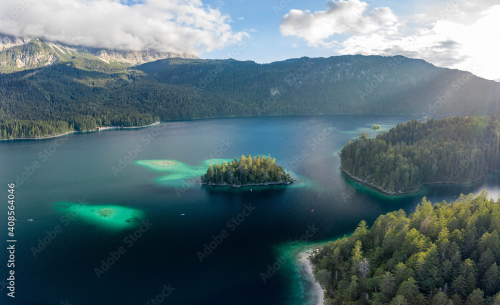 Aerial view of Eibsee lake island tree by Zugspitze before sunset in Germany
