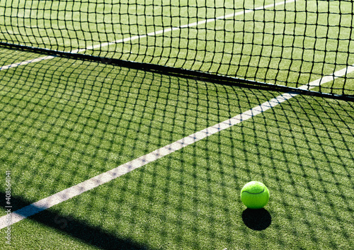 Tennis ball in a green tennis court