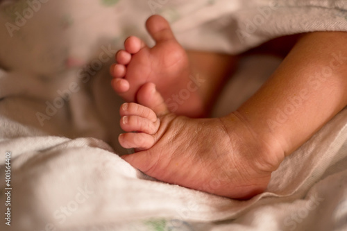 Tiny newborn baby feet, tiny bare feet of tiny newborns. Happy family concept © Orathai