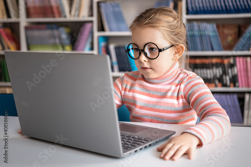 Girl using a laptop computer at school. High quality photo