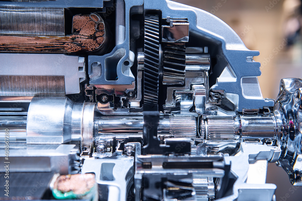 Motor of the electric car with powertrain and power connections closeup. Blue toned. EV car at maintenance. Motor of the electric car with powertrain and power connections closeup. Blue toned. EV car at maintenance.